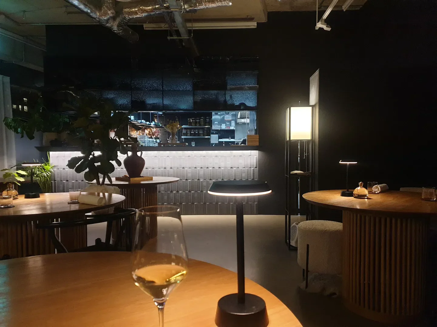 Interior of Oxeye restaurant in London, showing tables, bar, and elegant lighting.