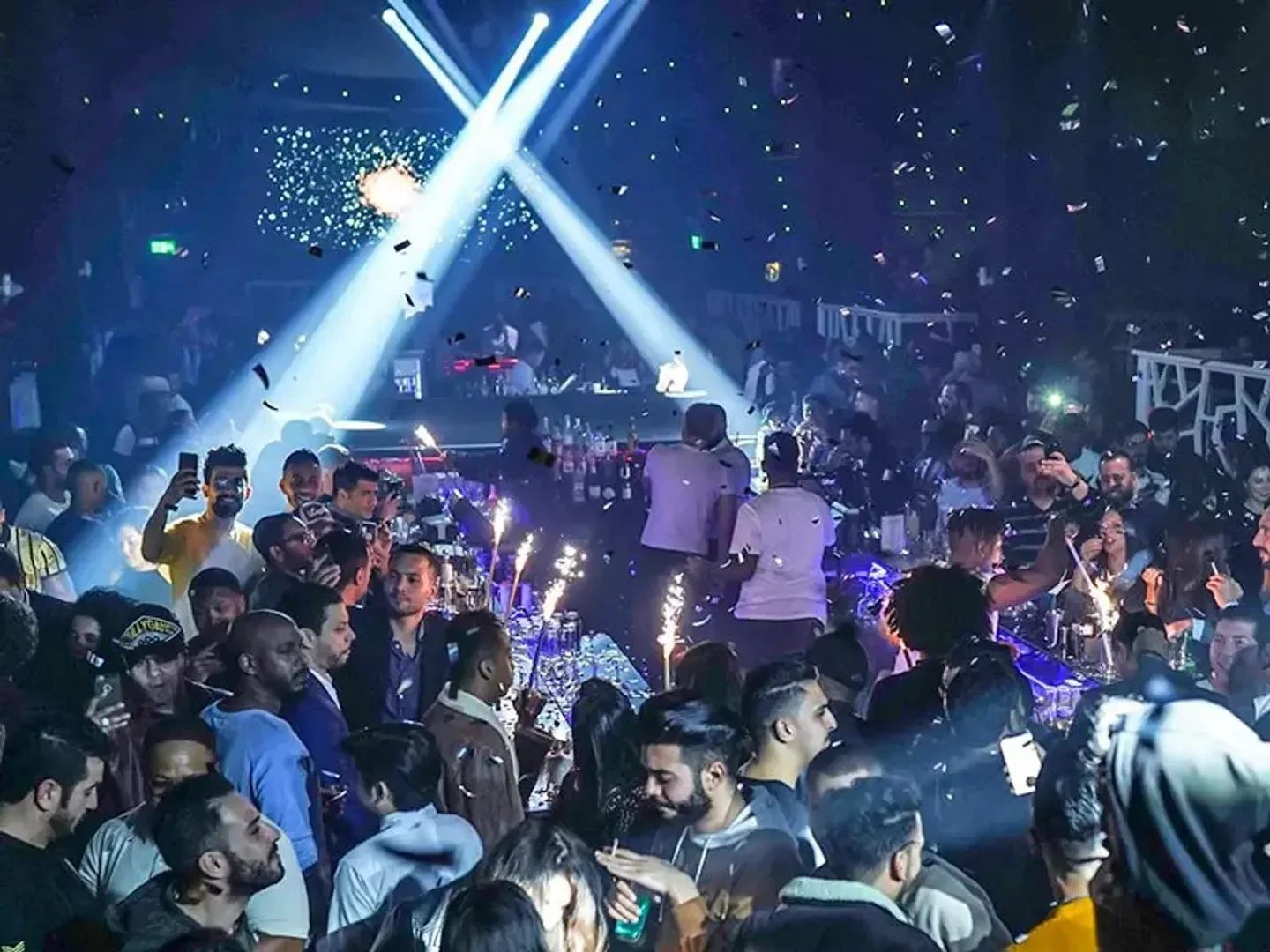 Energetic nightlife scene at Oxygene Club in Doha, with crowds and vibrant lighting.