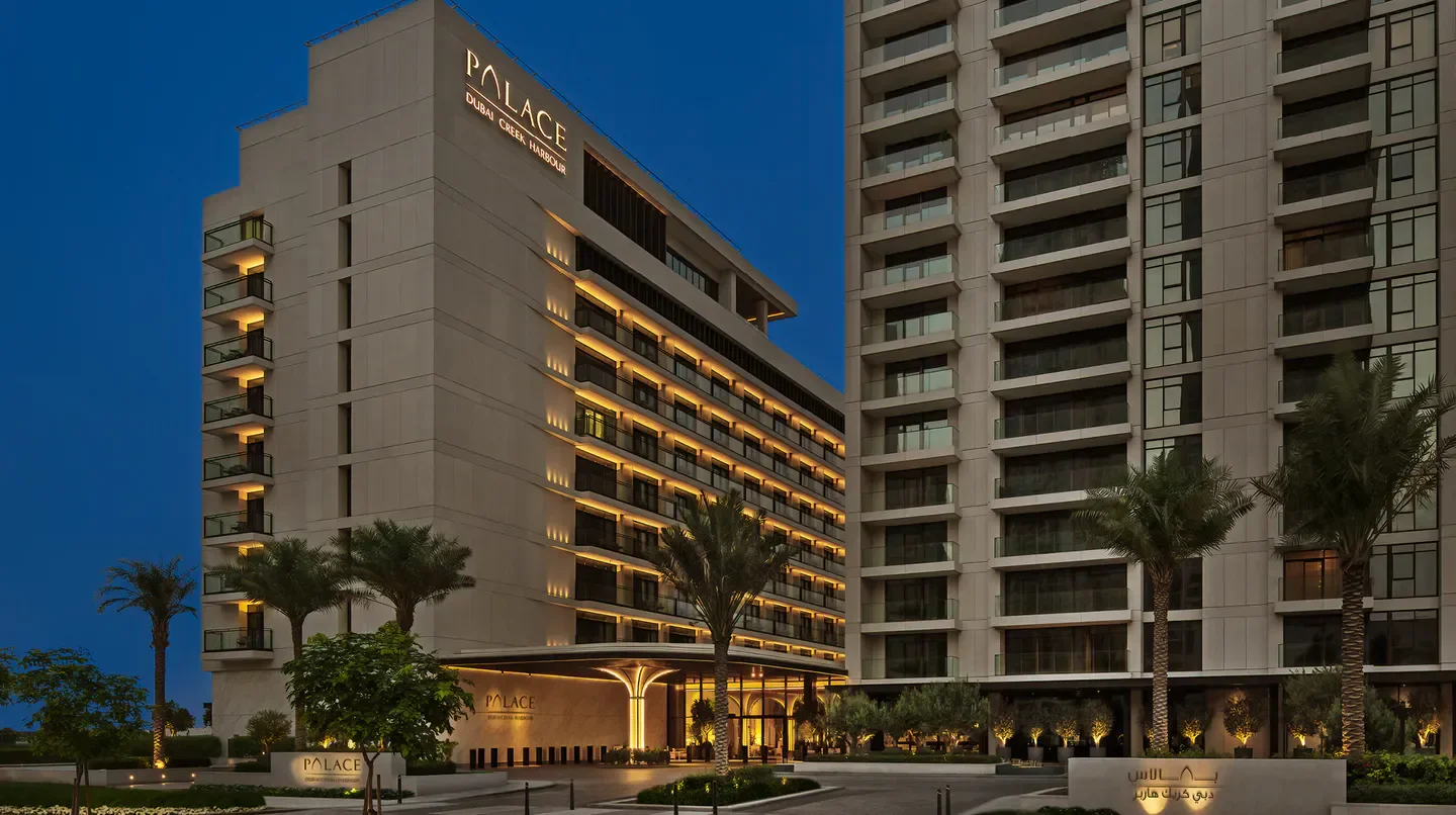 Exterior view of the Palace Dubai Creek Harbour hotel in Dubai at dusk.