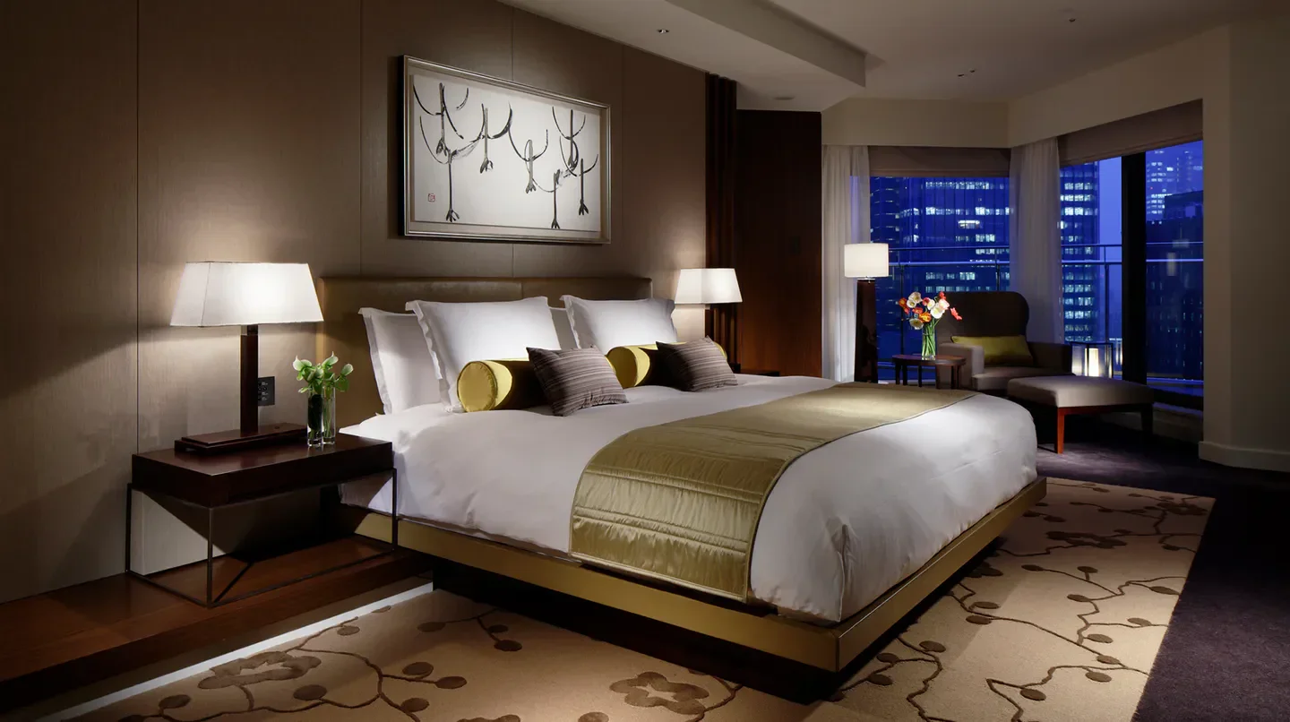 Luxury bedroom at Palace Hotel Tokyo with city views of Tokyo at night