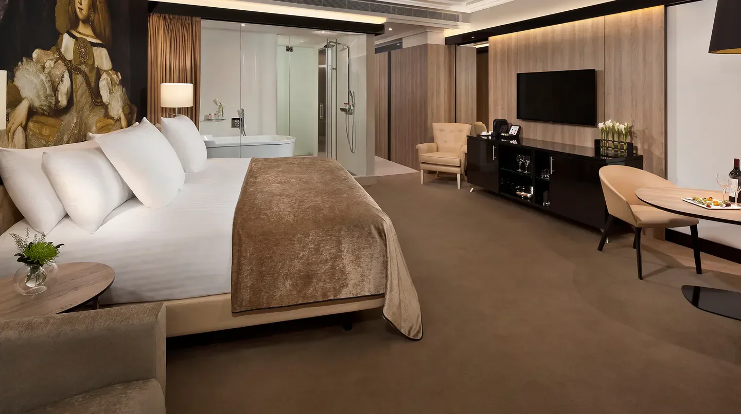 Luxury bedroom at Palacio de los Duques Gran Meliá in Madrid, featuring modern design and comfort