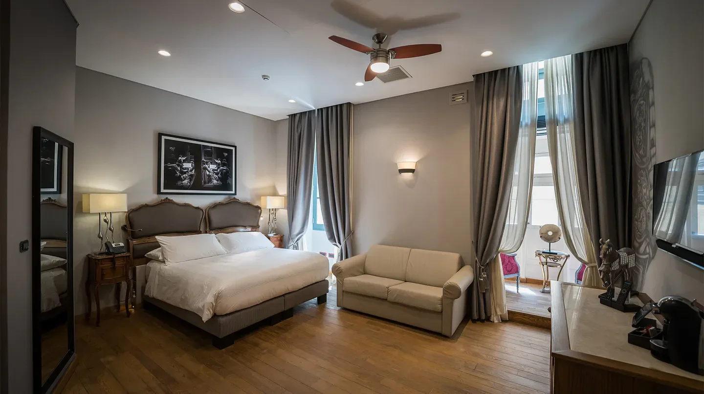 Cozy bedroom at Palazzo Consiglia in Malta, featuring elegant decor and a comfortable atmosphere.