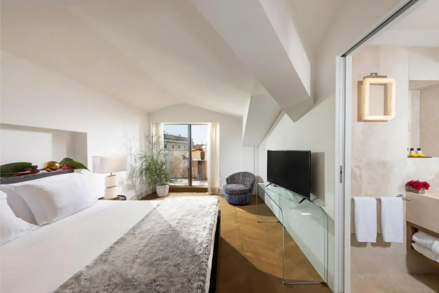 Elegant bedroom at Palazzo Manfredi hotel in Rome, with balcony view and modern design.