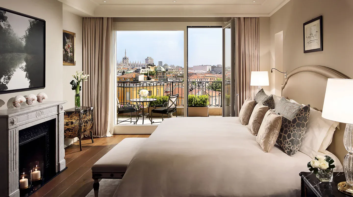 Bedroom view at Palazzo Parigi Hotel & Grand Spa Milano, overlooking Milan's skyline.