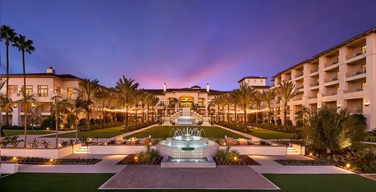 Park Hyatt Aviara Resort, Golf Club & Spa in San Diego at dusk with fountain and lights.
