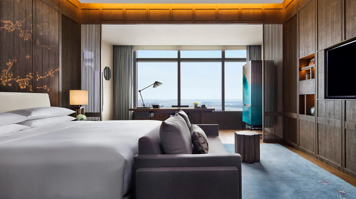 Luxury bedroom at Park Hyatt Hangzhou with city views in Hangzhou, China
