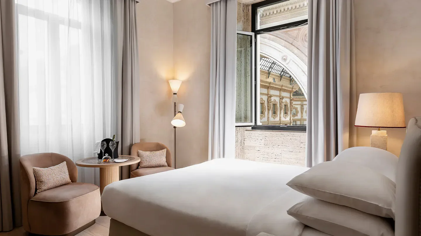 Cozy bedroom at Park Hyatt Milan, with a view of Milan's iconic architecture.