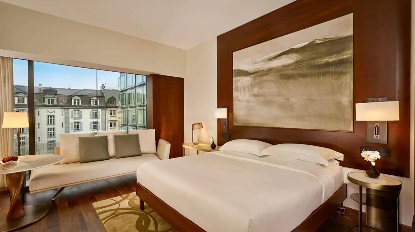 Cozy bedroom at Park Hyatt Zurich, overlooking the beautiful city of Zurich.