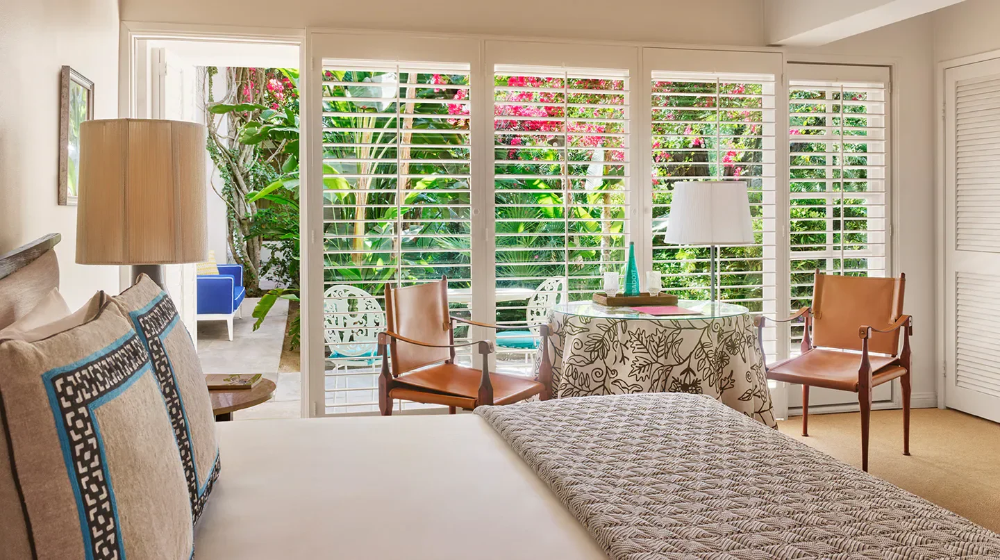 Interior bedroom view at Parker Palm Springs in Palm Springs with garden and shuttered windows