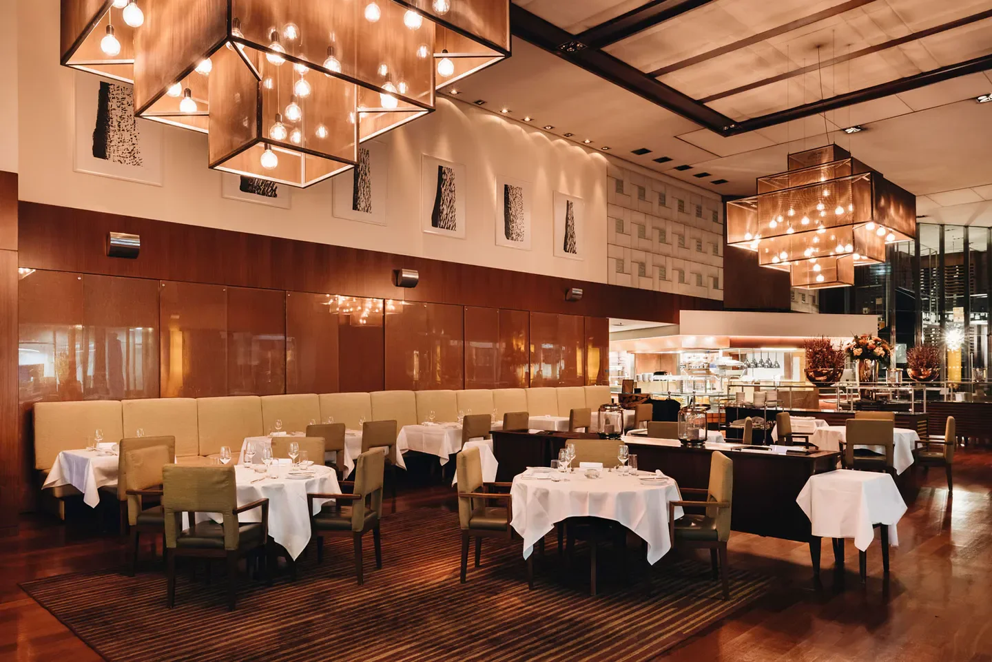 Elegant dining room interior at Parkhuus restaurant in Zurich, featuring modern light fixtures