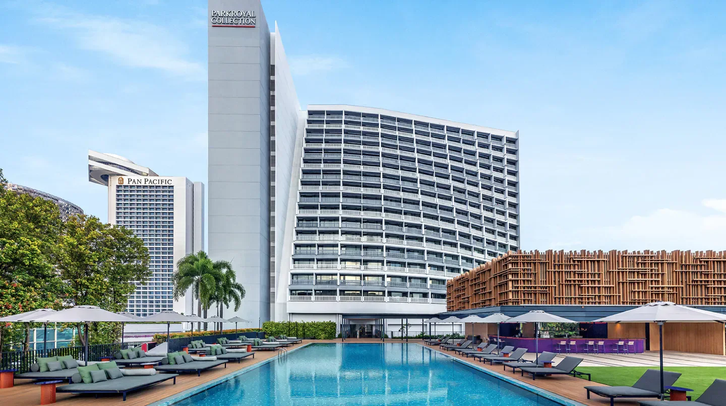 Pool and hotel exterior at PARKROYAL COLLECTION Marina Bay, Singapore, during the day.