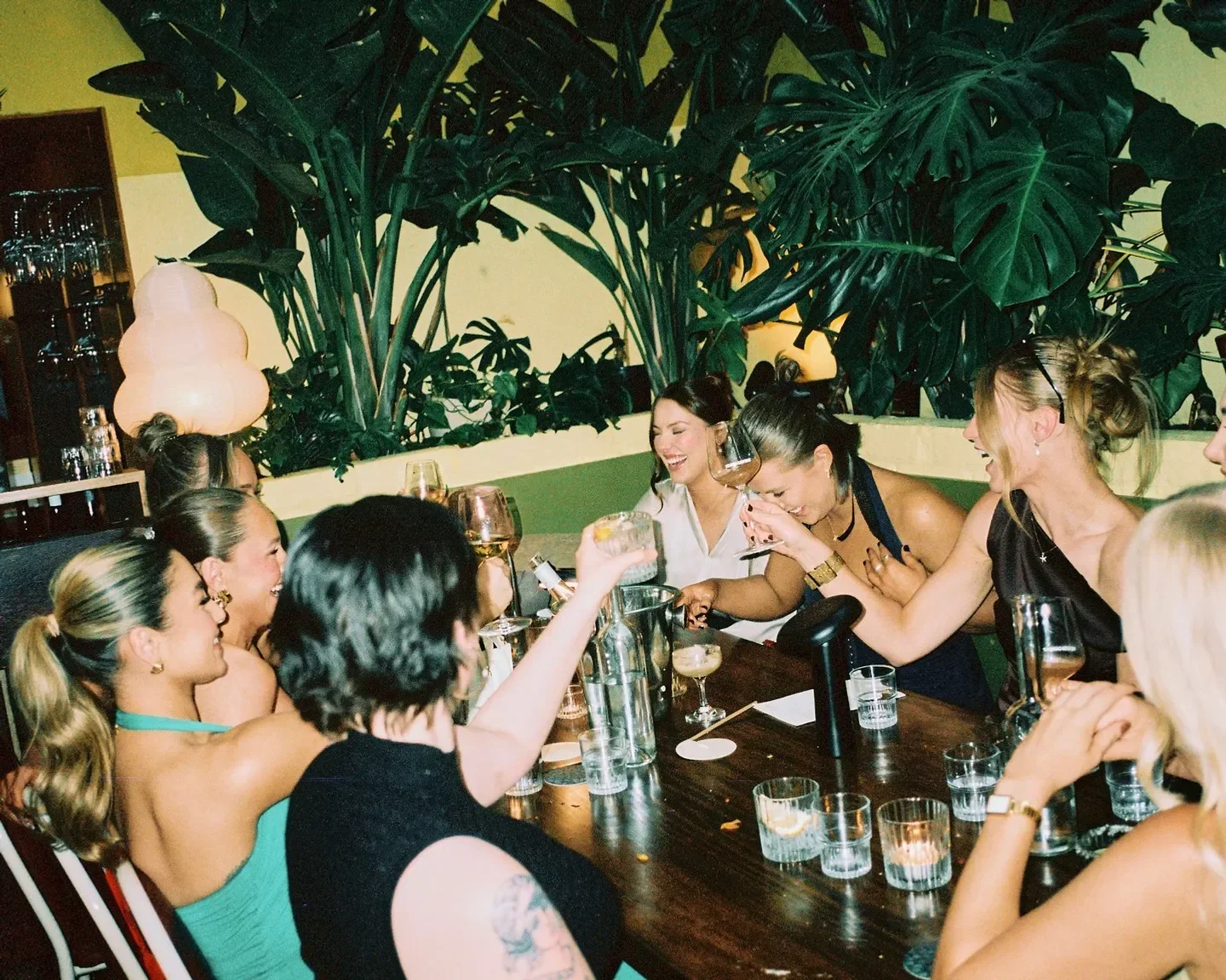 Group of friends laughing at Pastel Wine Bar in Adelaide, enjoying drinks and cocktails.