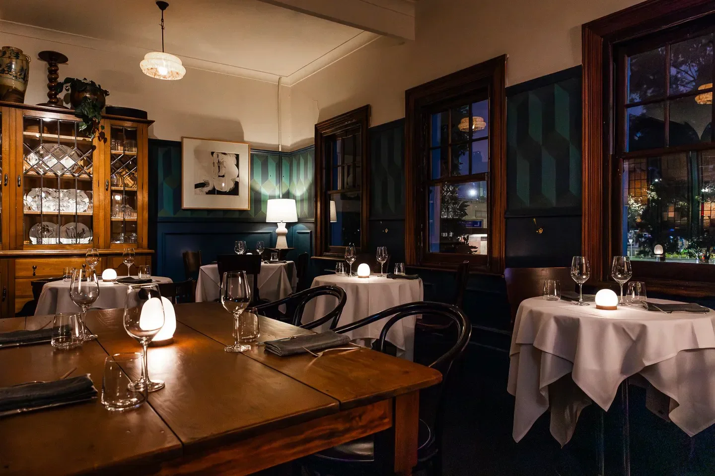 Cozy dining room at Patsy's restaurant in Melbourne, with tables set for dinner.