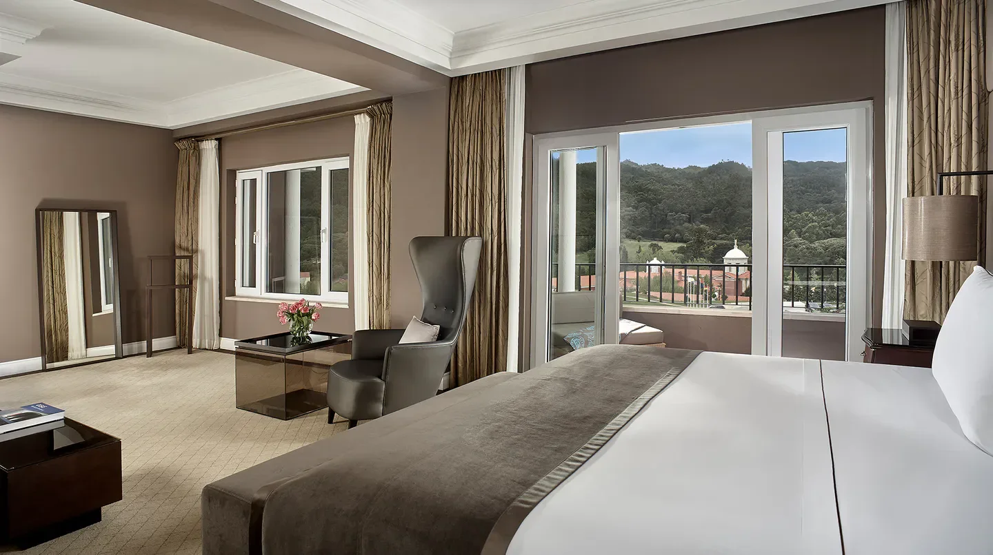 Elegant hotel room at Penha Longa Resort in Lisbon with balcony view