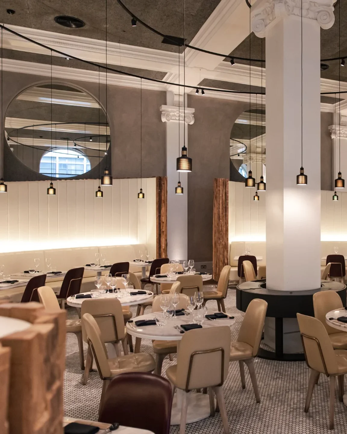 Peter Street Kitchen restaurant interior in the city, featuring elegant dining tables and modern pendant lights.