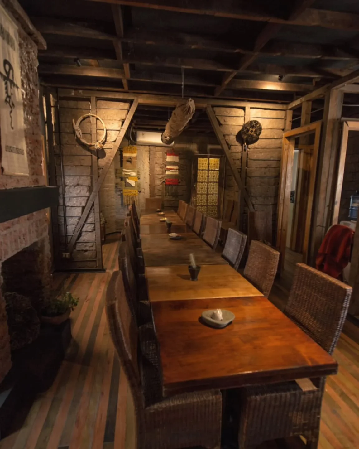 Cozy interior dining at Peumayén Ancestral Food in Santiago, featuring wooden tables and a rustic ambiance.