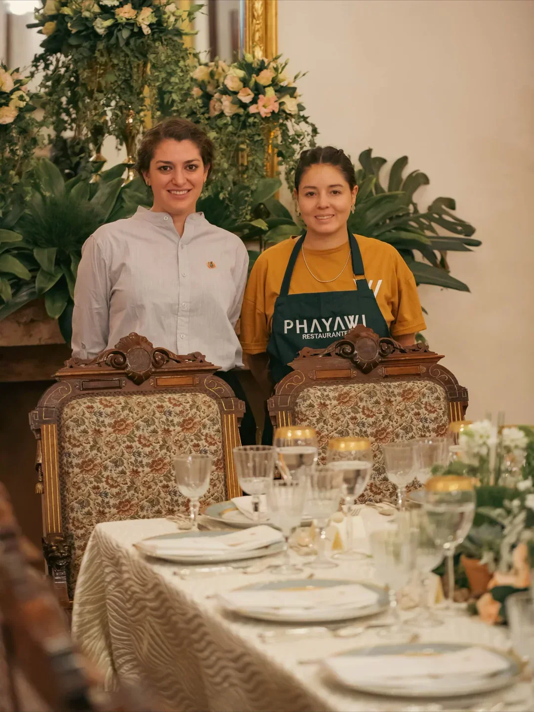 Staff at Phayawi restaurant in La Paz, posing in front of a beautifully set table.