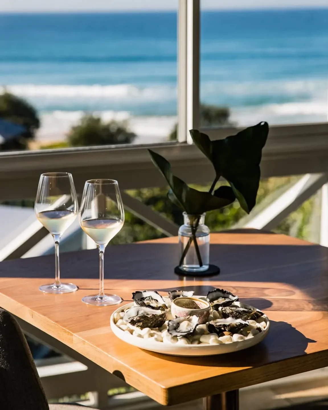 Oysters and wine at Pilu at Freshwater, Sydney, with stunning ocean views.