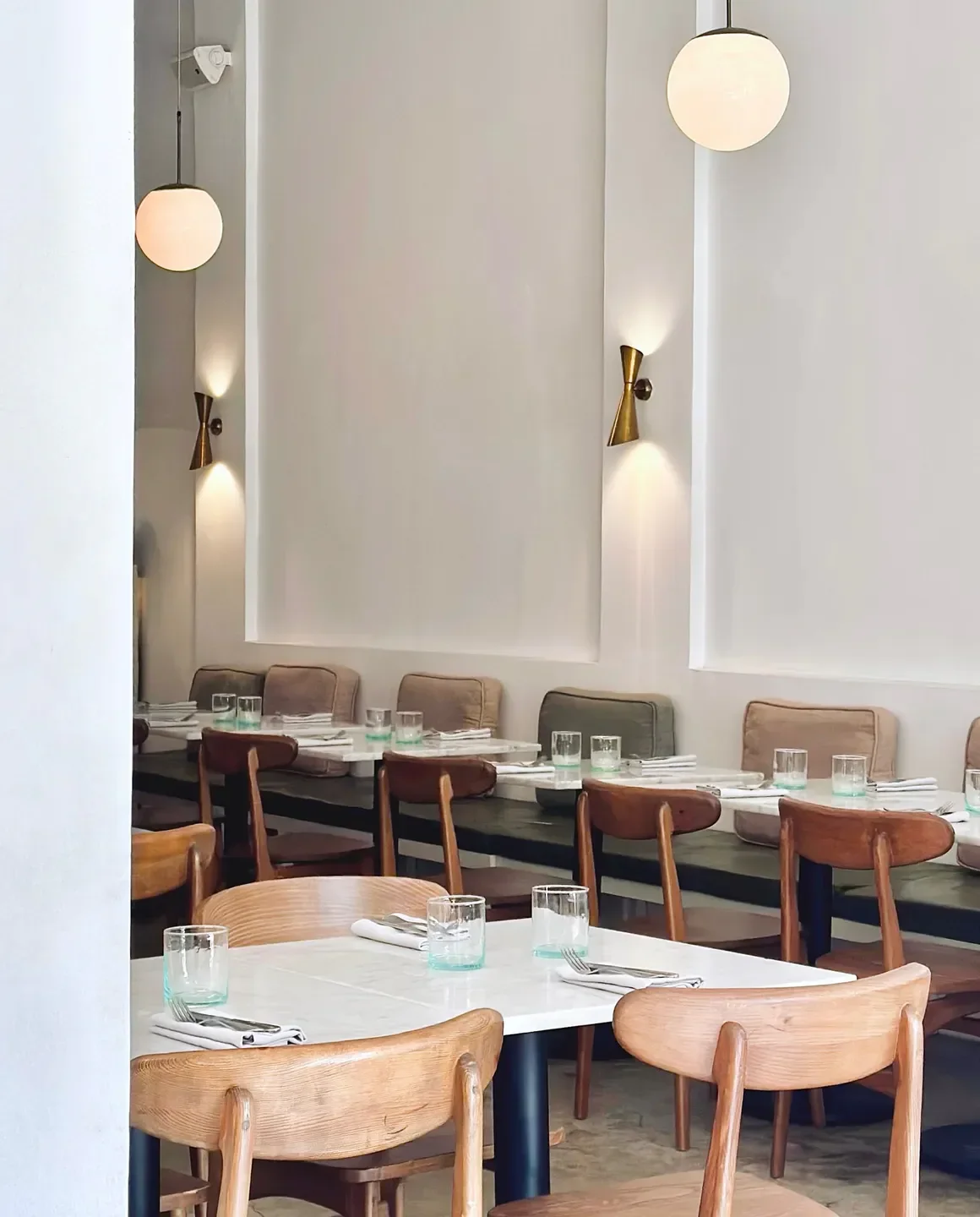 Interior view of Plus61 restaurant in Marrakech, showcasing tables, chairs, and lighting.