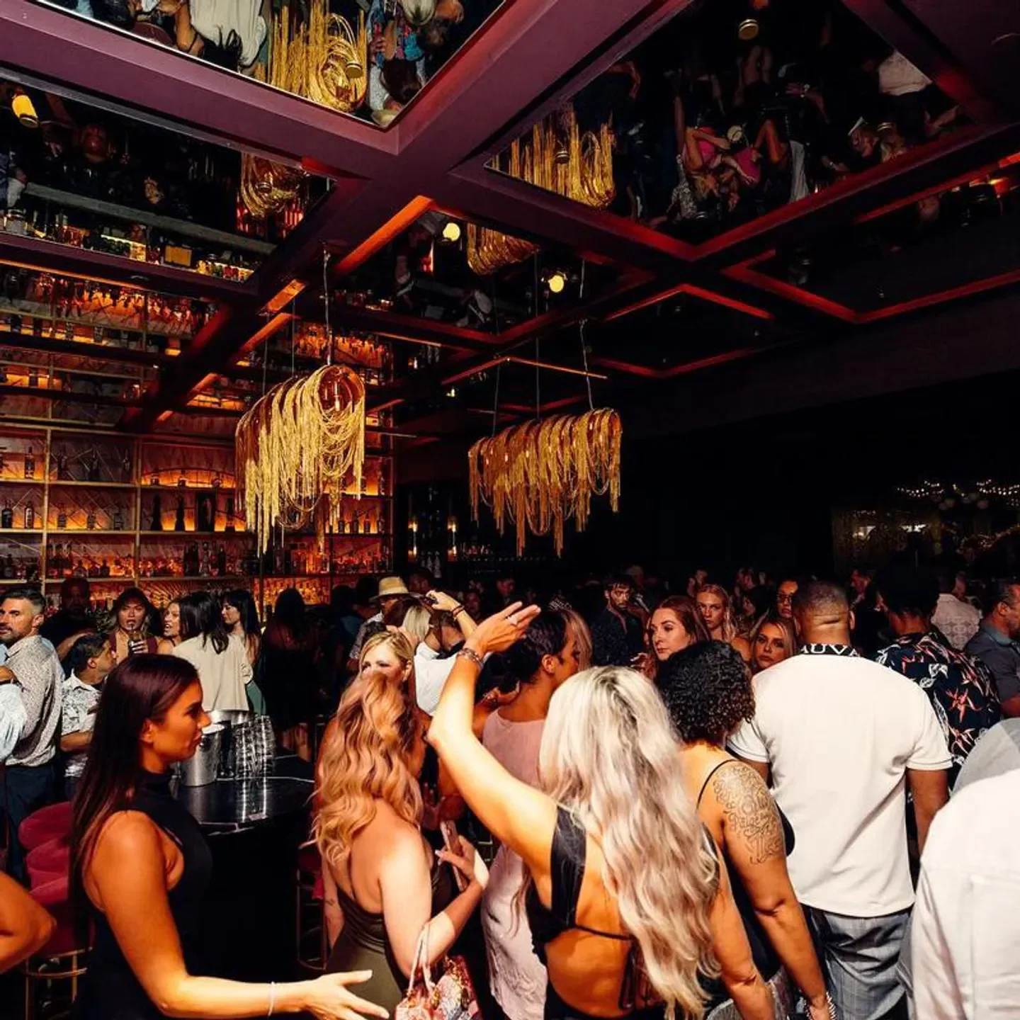 Busy crowd enjoying the nightlife scene at PM Lounge in Dallas, with stylish decor.