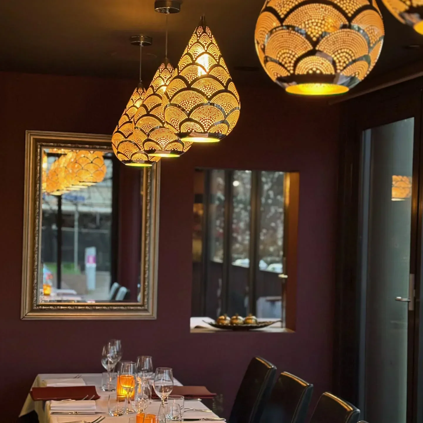 Interior of Pomegranate Restaurant in Canberra, featuring stylish lighting and table setting.