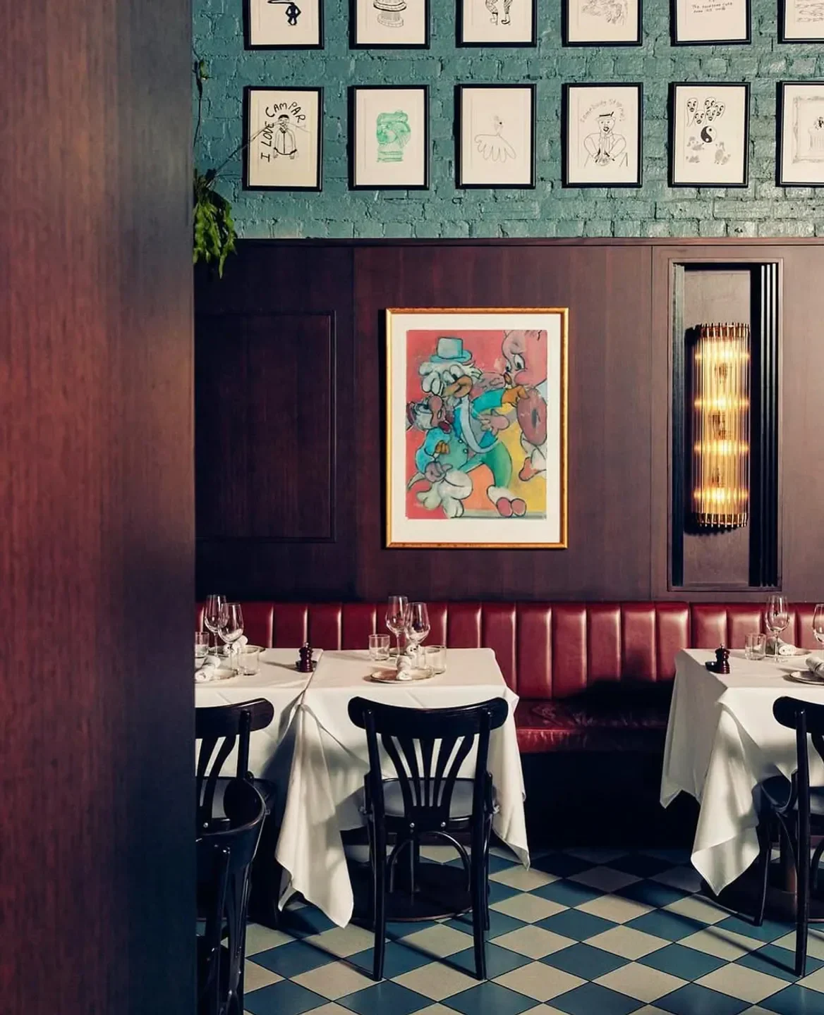 Interior of Poodle Bar & Bistro in Melbourne, featuring tables, artwork, and a unique design.