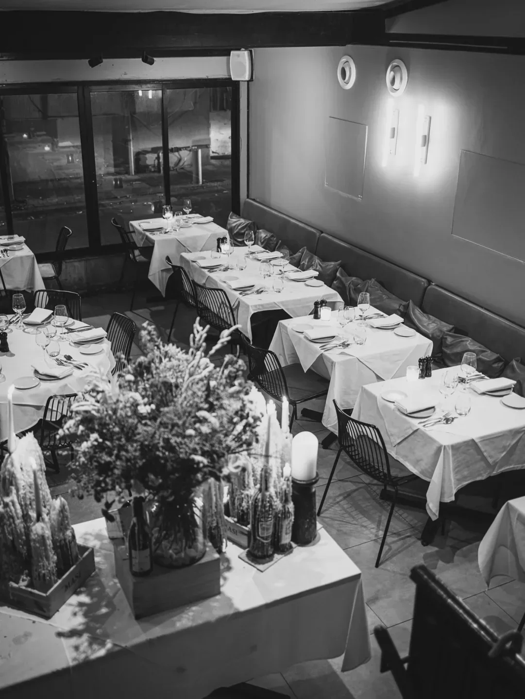 Cozy dining room interior at Popina restaurant in Tel Aviv, with elegant table settings.