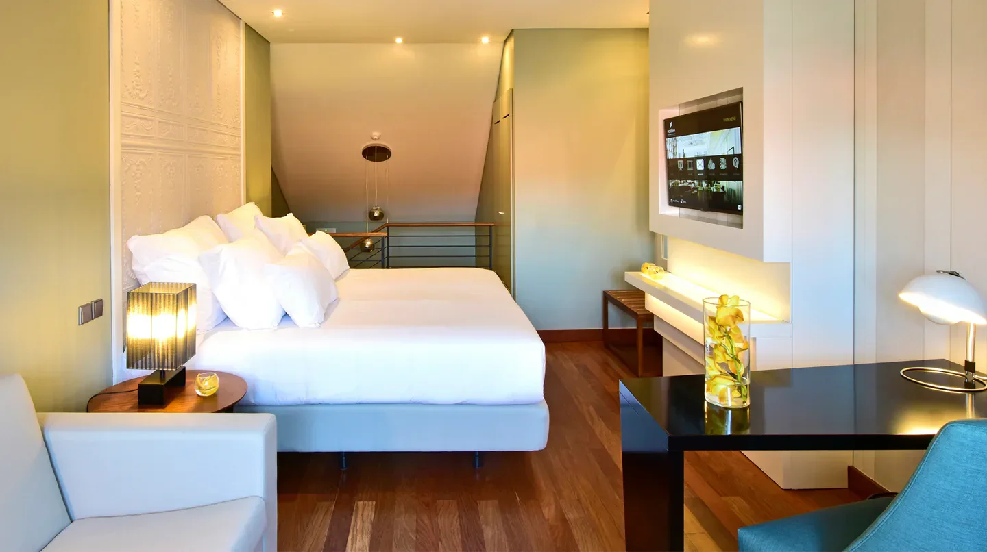 Cozy bedroom at Pousada de Lisboa hotel in Lisbon, featuring modern design and lighting.