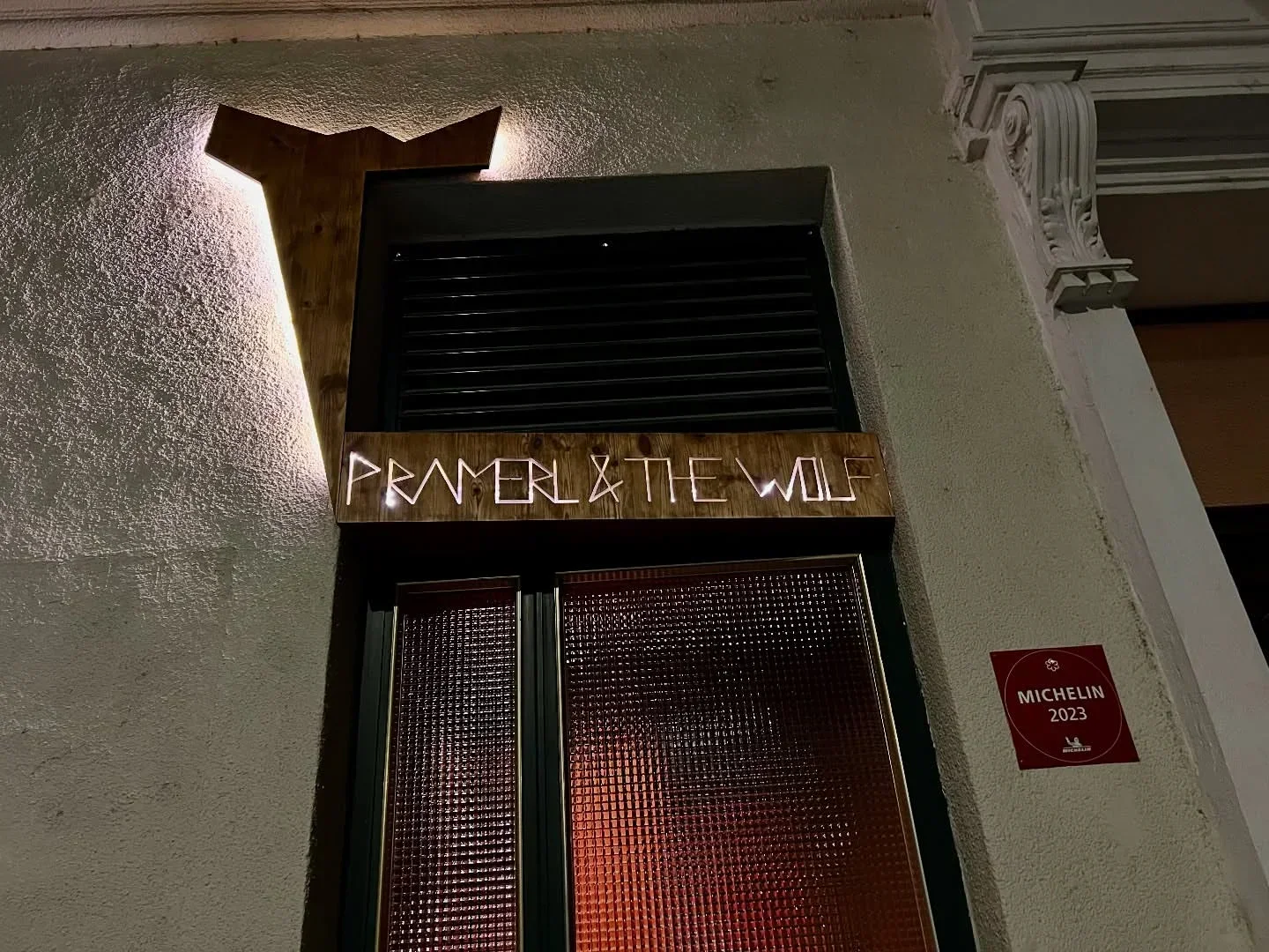 Entrance of Pramerl & the Wolf restaurant in Vienna, with a Michelin 2023 award.