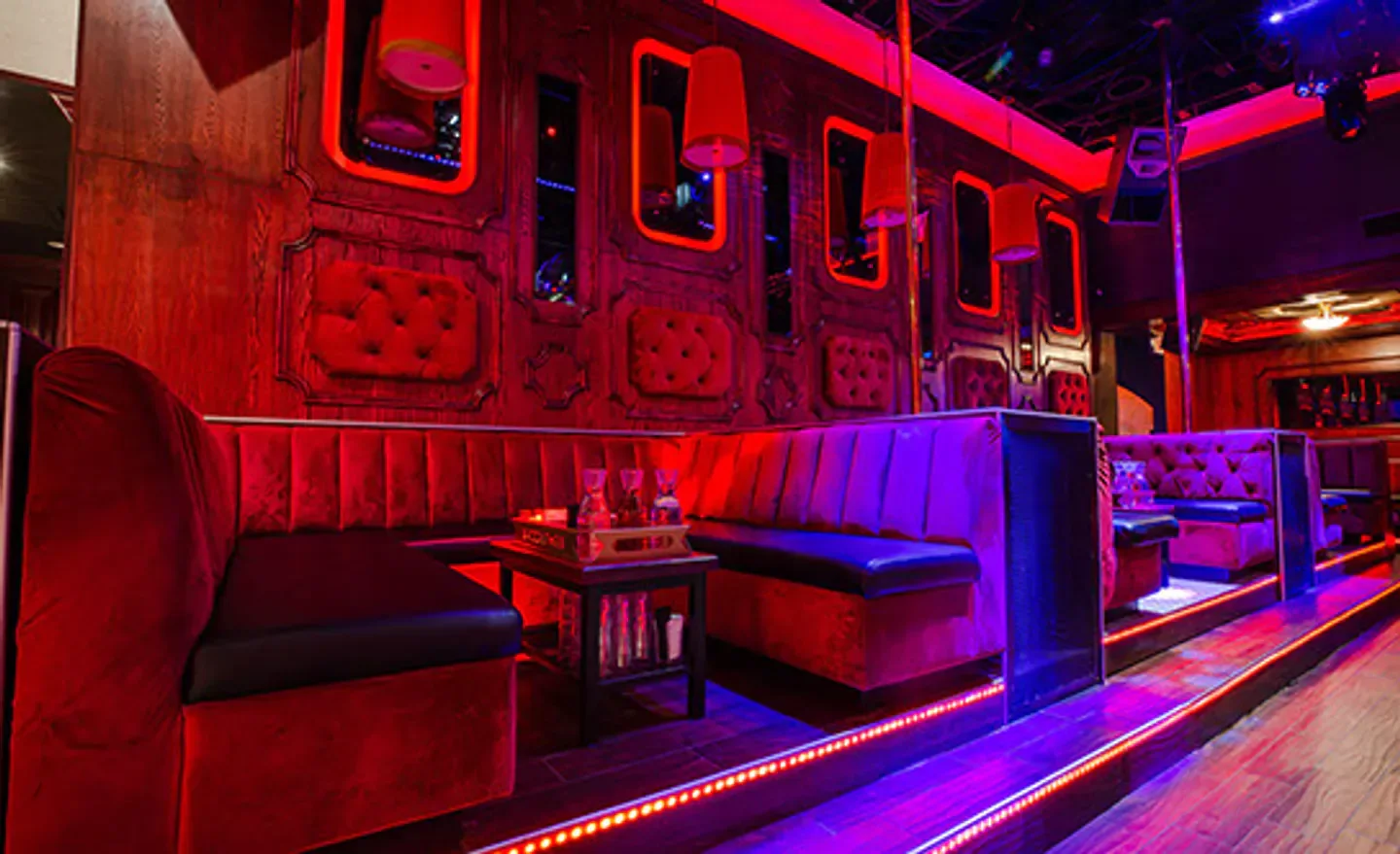 Interior of Pretty Please Lounge in Scottsdale, red velvet booths and nightclub lighting