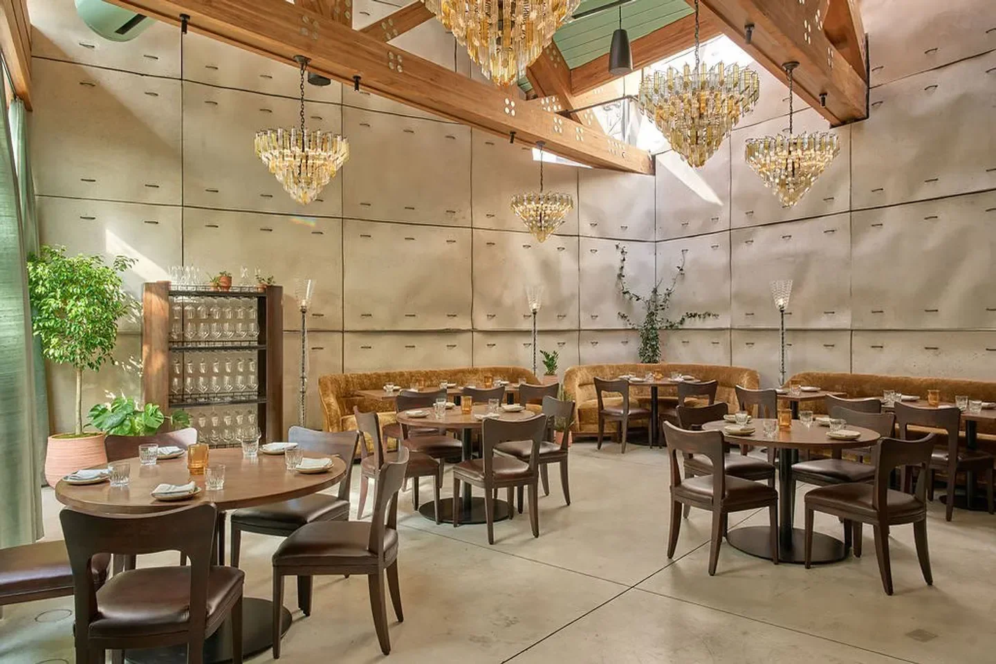Interior of Principe restaurant in New York City with chandeliers, tables, and seating.