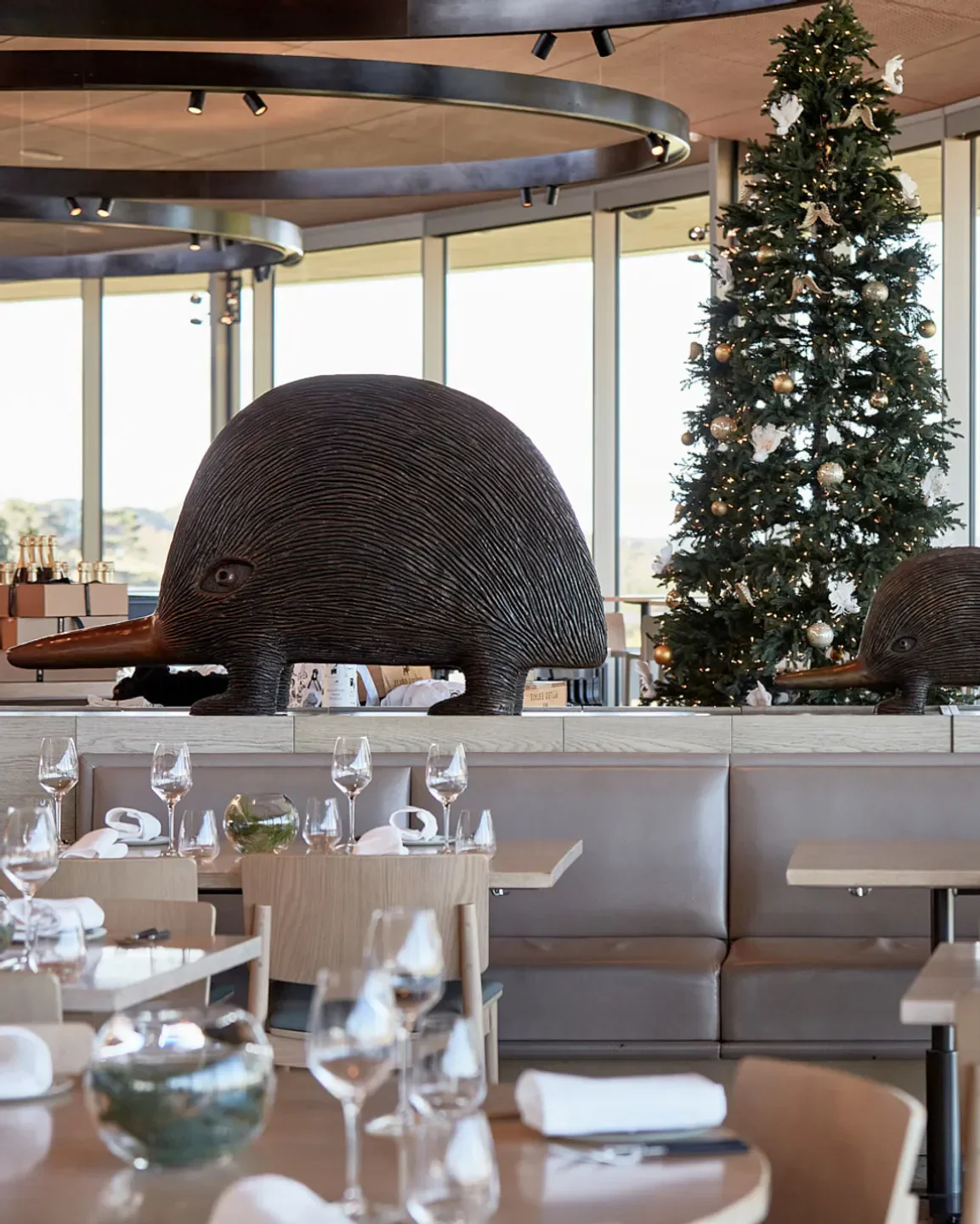 Pt. Leo Estate Restaurant in Mornington Peninsula, dining room with sculptures and festive decor.