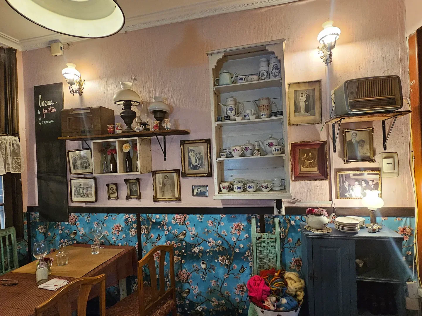 Cozy interior of Pulpería Santa Elvira restaurant in Santiago, decorated with vintage details.