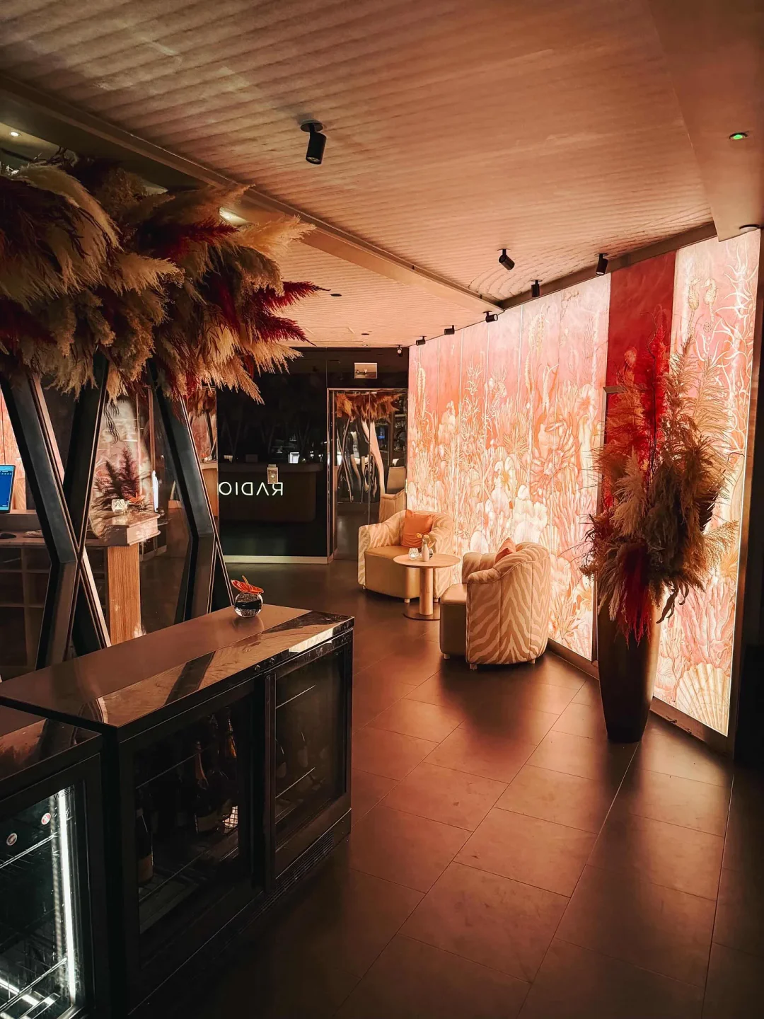 Inviting interior of Radio Rooftop London featuring plush seating and vibrant illuminated wall art