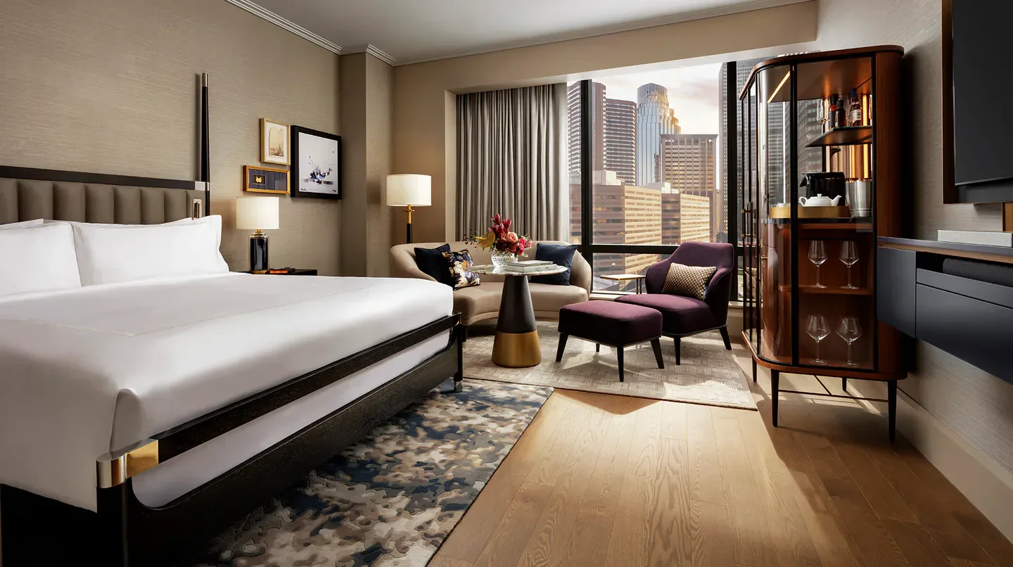 Luxury hotel room at Raffles Boston with city views of Boston through large windows