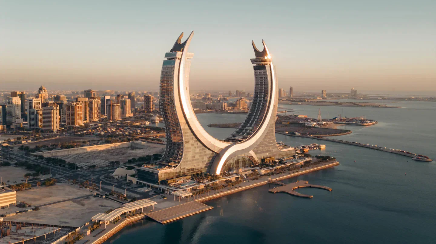 Stunning architecture of Raffles Doha hotel in Doha overlooking the Arabian Gulf at sunset