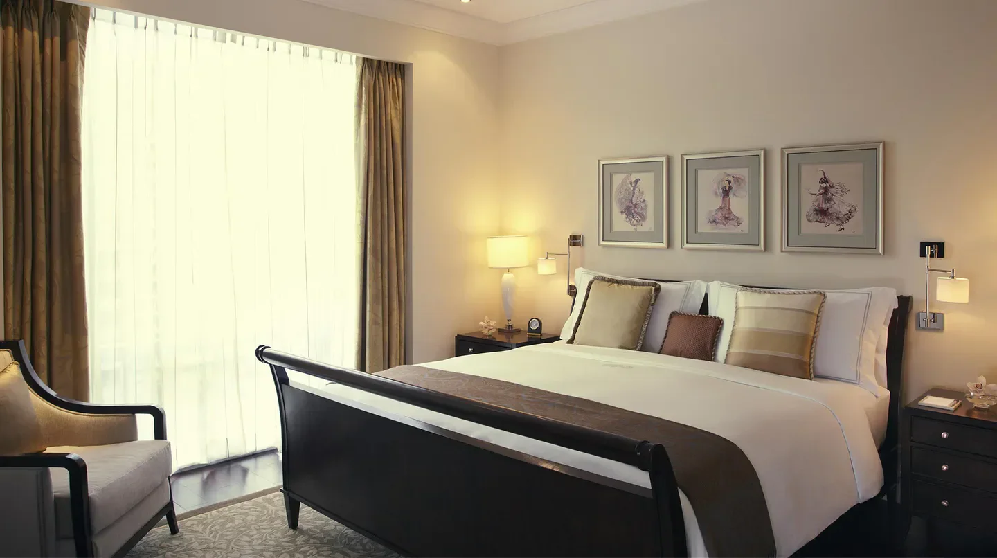 Cozy bedroom at Raffles Makati, Manila, featuring a comfortable bed and elegant decor