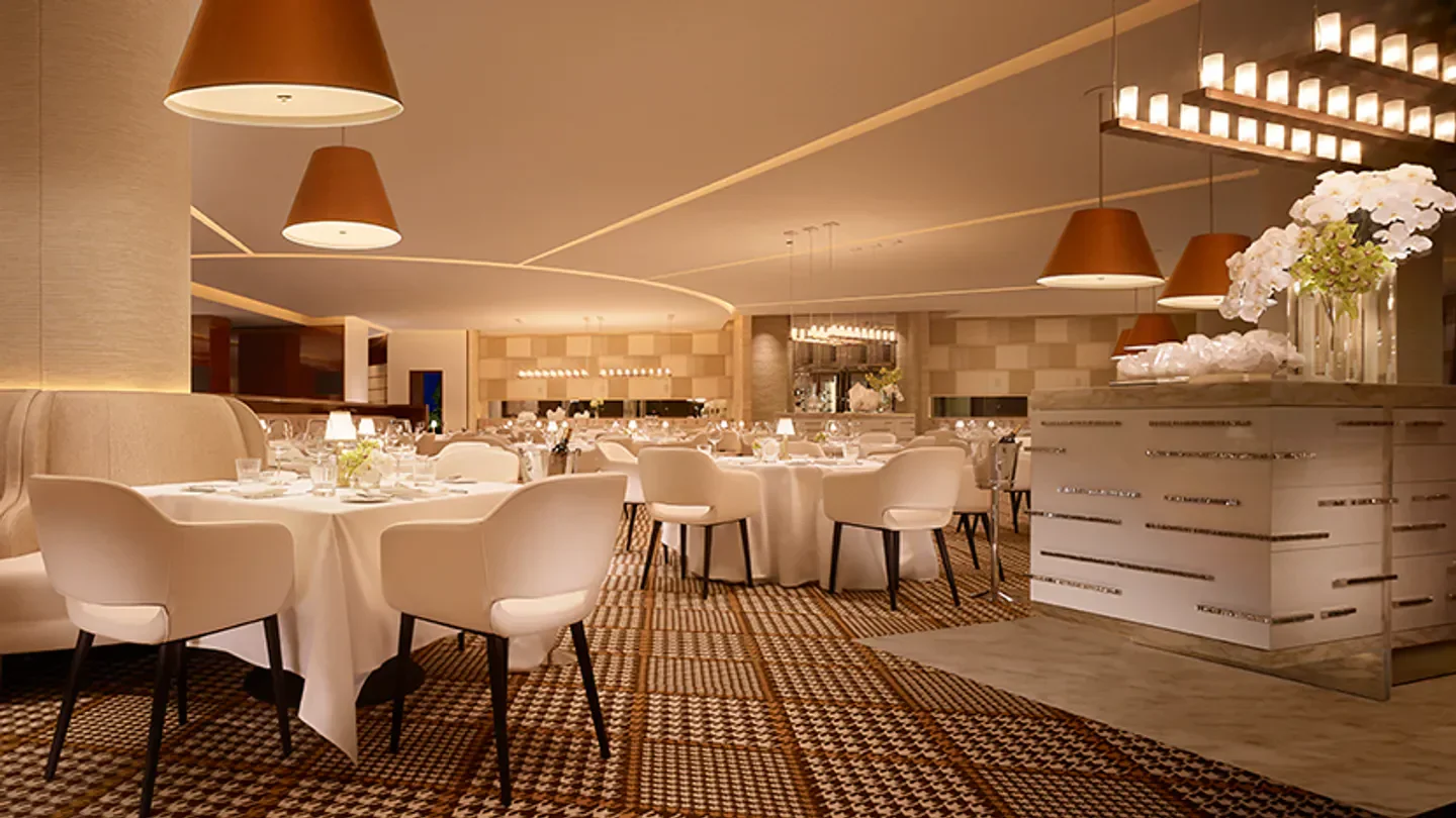 Elegant dining area at Rare Steakhouse in Boston, with modern lighting and decor.