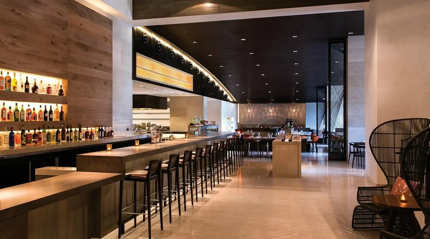 Interior of Ravello restaurant in Orlando, featuring a long bar and cozy seating area.