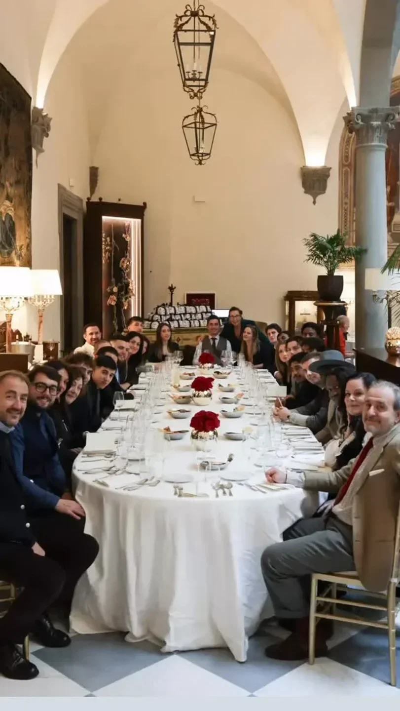 Group dining at Regina Bistecca restaurant in Florence, Italy, enjoying a festive dinner
