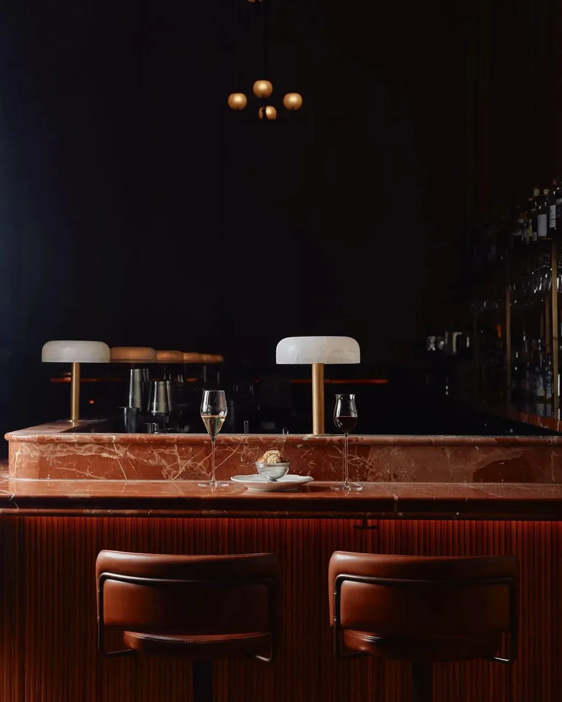 Interior bar at Reine & La Rue restaurant in Melbourne with stylish lighting and drinks.