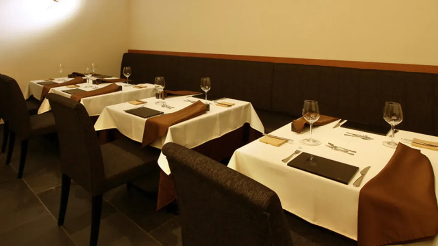 Elegant dining tables at Reine des Prés restaurant in Kyoto, Japan, ready for service.
