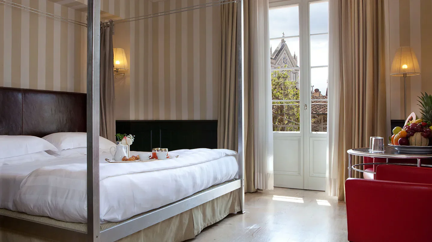 Cozy bedroom at Relais Santa Croce in Florence, featuring a view of the city.