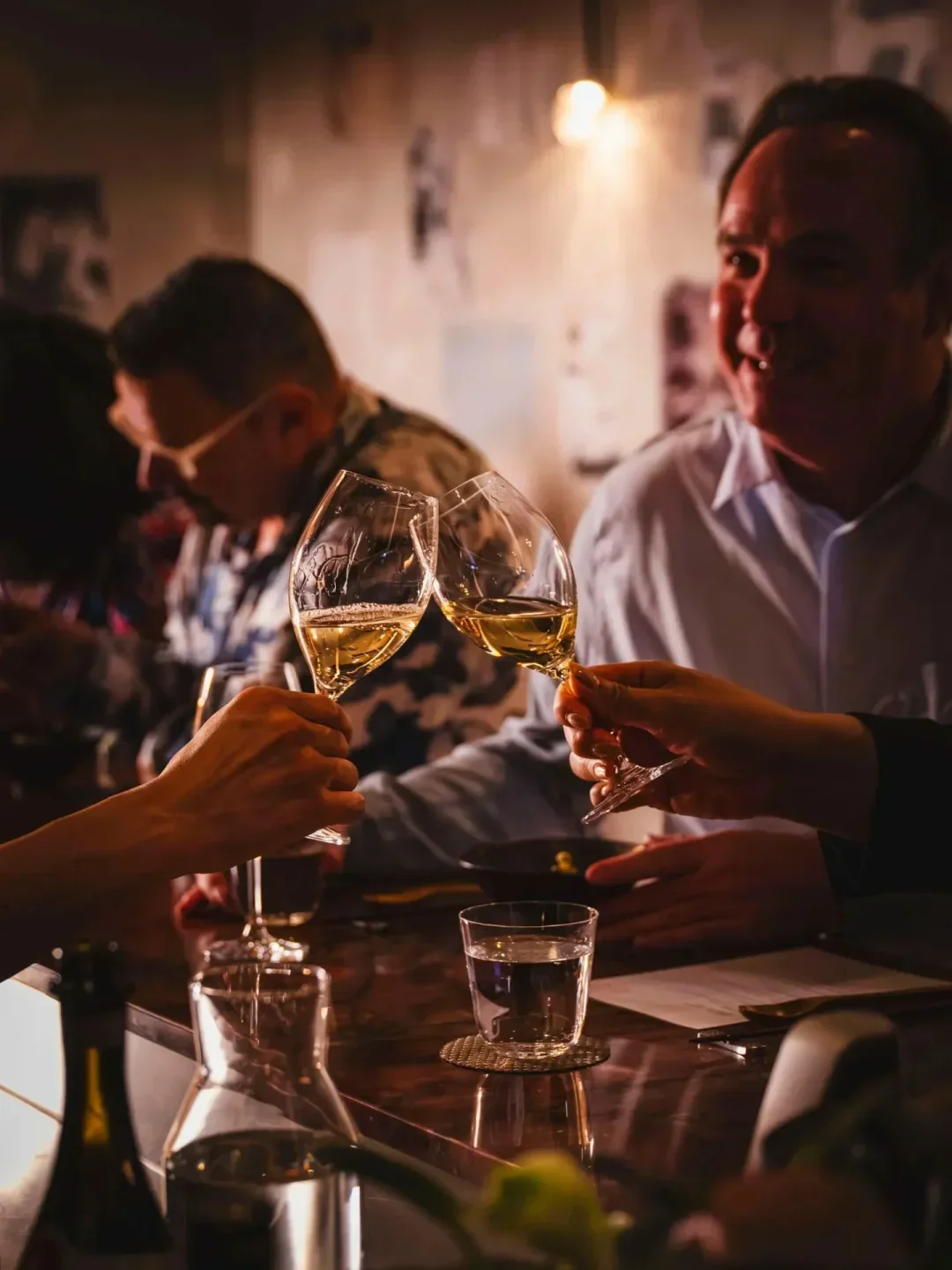 Cheers at Restaurant Ka in Sydney, celebrating with glasses of wine.