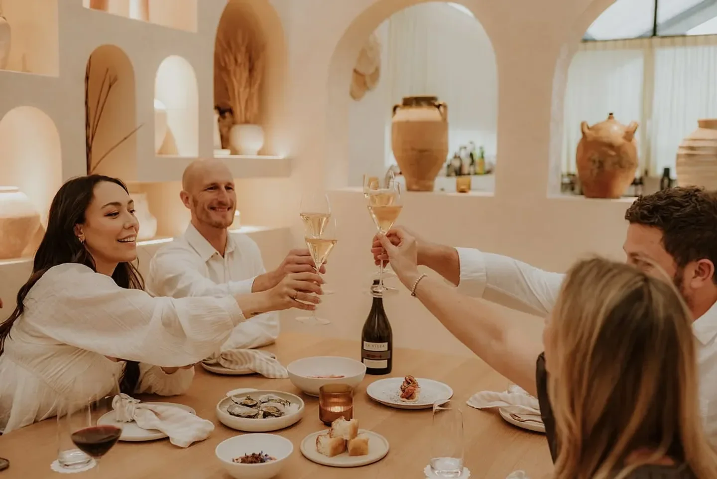 Restaurant MARIA in Hobart: Friends toasting with champagne during a celebratory dinner