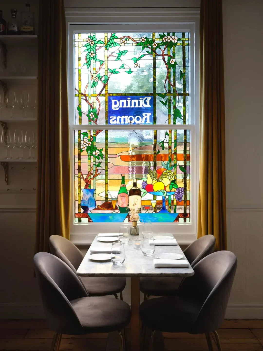 Restaurant Twenty Two in Cambridge: Dining room with a beautiful stained-glass window
