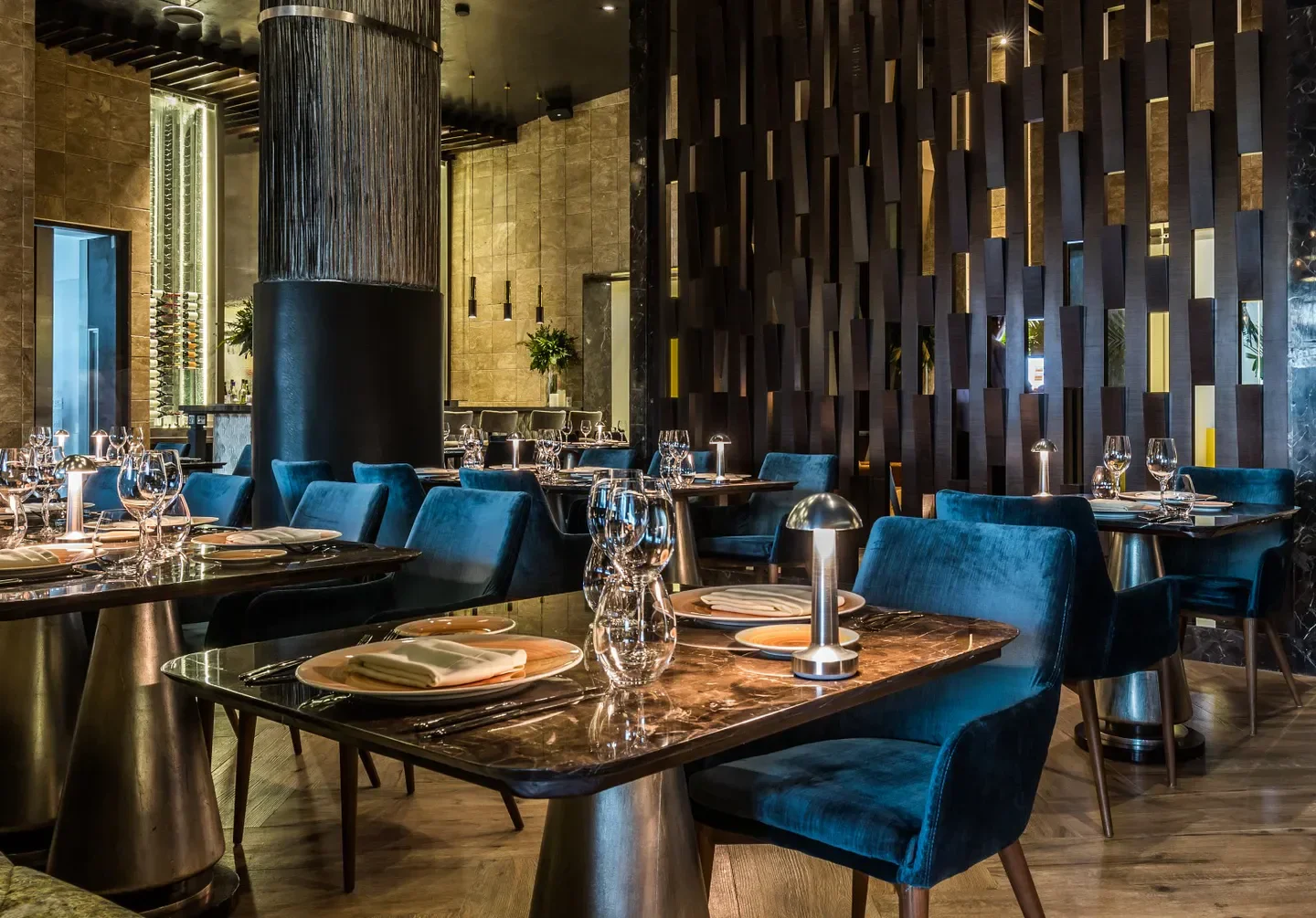 Elegant interior dining at Restaurante Lucca in Puerto Vallarta with velvet chairs and table settings.