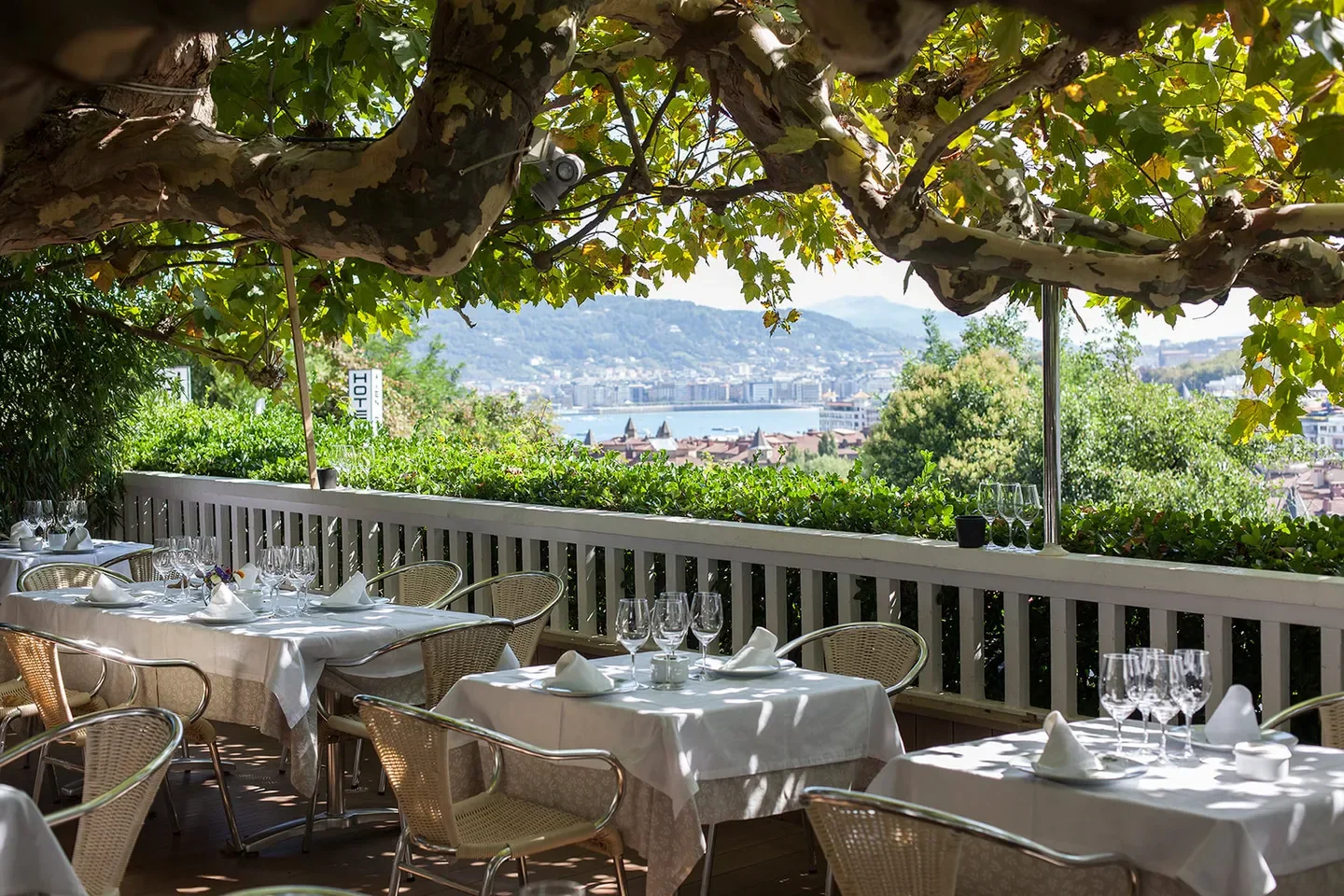 Outdoor dining at Restaurante Rekondo in San Sebastian with a view of the city.