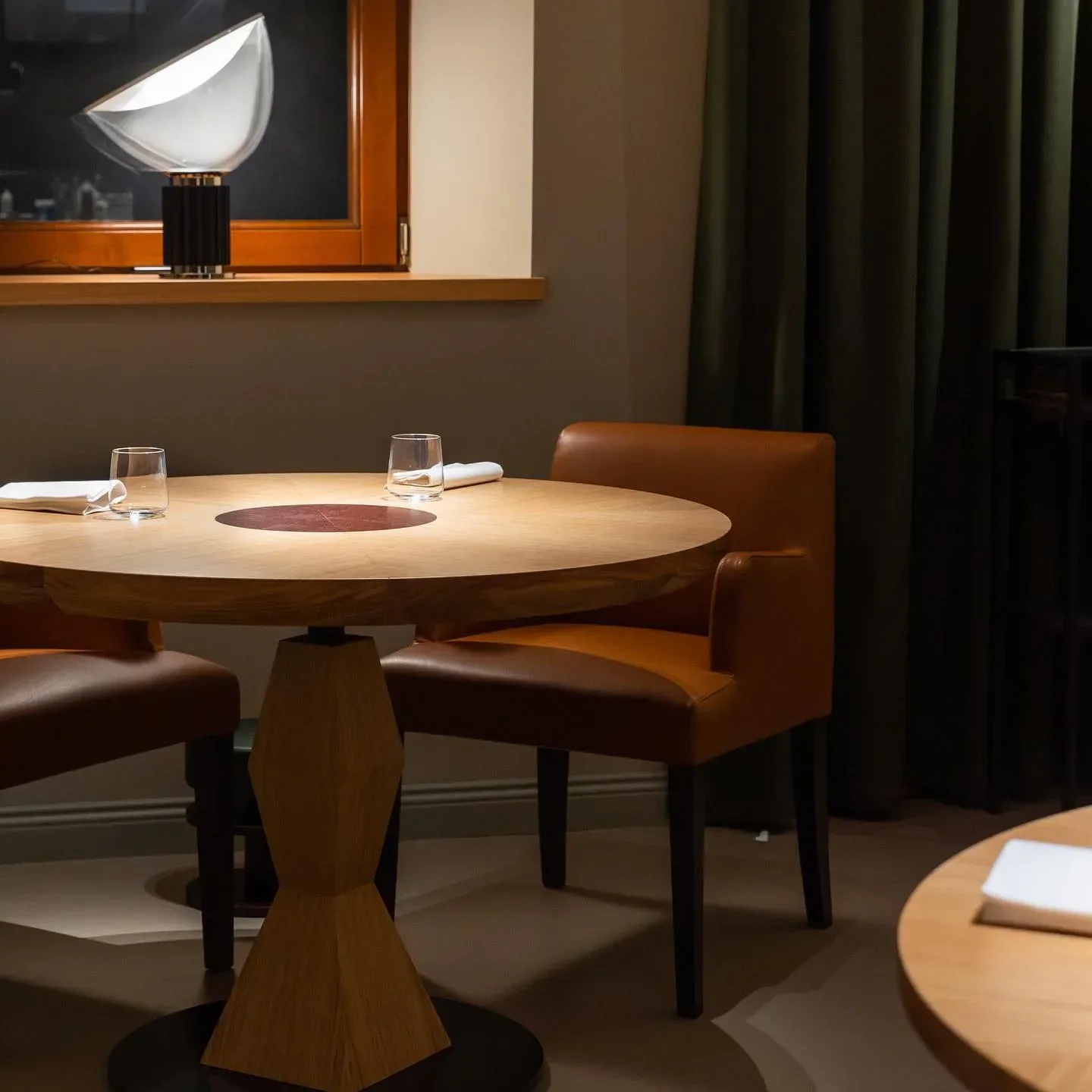 Cozy dining area at Retroscena restaurant in Marche, Italy, featuring a stylish table setting.