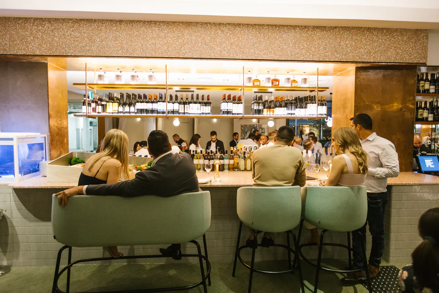 Rico Bar Dining in Brisbane: stylish interior with bar seating and bottles on display